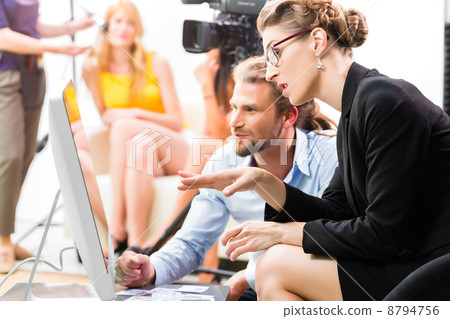 Film team discussing direction for video production 8794756