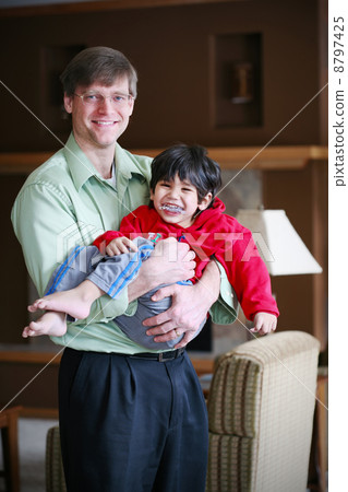 Father holding his disabled three year old son 8797425