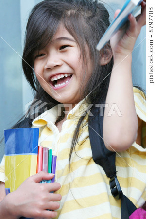 Girl excited about her new schoolbooks Girl excited about her new schoolbooks 8797703