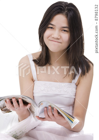 Young teenage girl in white dress gown with irritated expression Young teenage girl in white dress gown with irritated expression 8798132