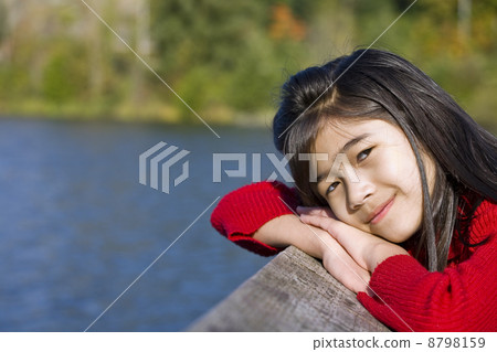 Little girl relaxing by lake Little girl relaxing by lake 8798159