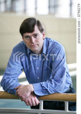 handsome businessman by railing handsome businessman by railing 8798274