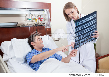 Doctor showing X-ray report Doctor showing X-ray report 8800676