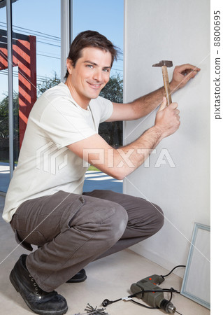 Young man with hammer 8800695