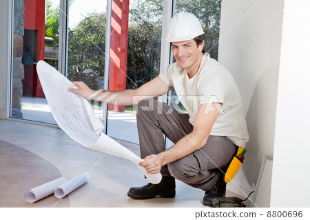 Smiling man with blueprint 8800696