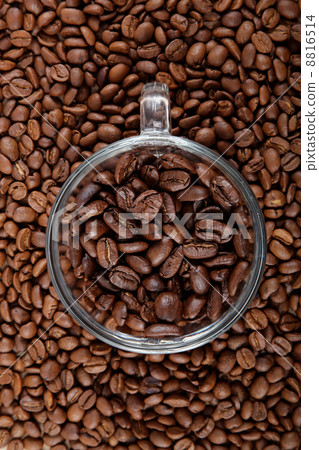 Glass coffee cup on the background of coffee beans. Glass coffee cup on the background of coffee beans. 8816514