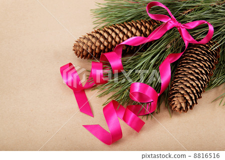 Christmas decorations. Spruce branch with cones and pink ribbon. Christmas decorations. Spruce branch with cones and pink ribbon. 8816516