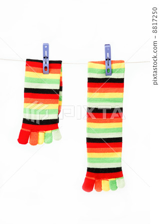 Colorful fun socks attached clothespin hanging from a rope. Colorful fun socks attached clothespin hanging from a rope. 8817250