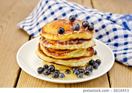Flapjacks with blueberries and a napkin on the board Flapjacks with blueberries and a napkin on the board 8818453