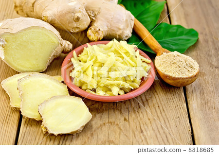 Ginger grated in a bowl with the powder in the spoon 8818685