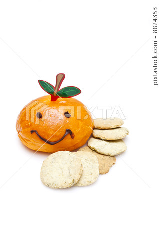 Orange smiley bread with biscuits on white background Orange smiley bread with biscuits on white background 8824353
