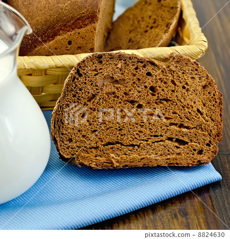 Rye homemade bread with milk on the board 8824630