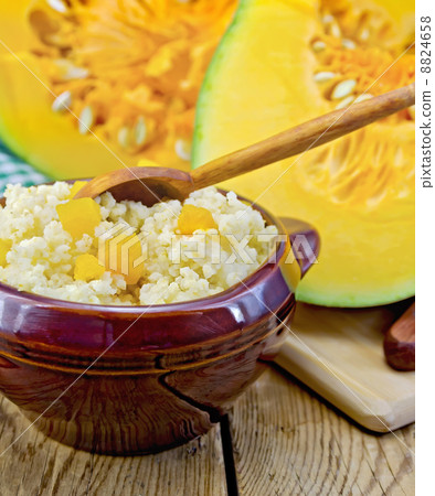 Porridge millet with pumpkin and spoon 8824658