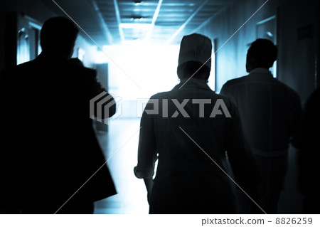 Doctors walking down the hall to save a life 8826259