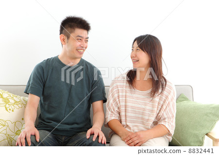 Middle-aged couple sitting in a chair Middle-aged couple sitting in a chair 8832441