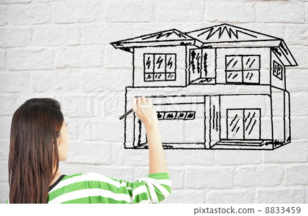 woman draw house on brick wall 8833459