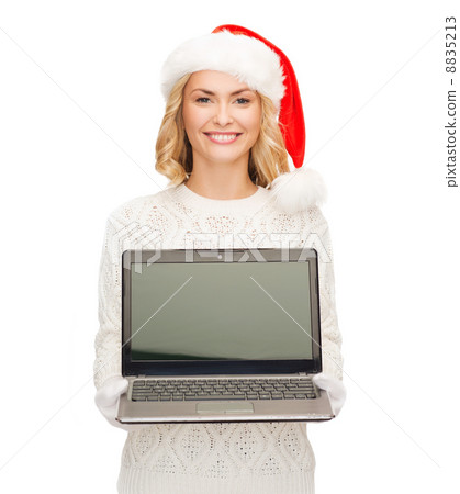 woman in santa helper hat with laptop computer 8835213