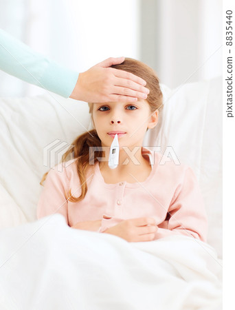 ill girl child with thermometer and caring mother ill girl child with thermometer and caring mother 8835440