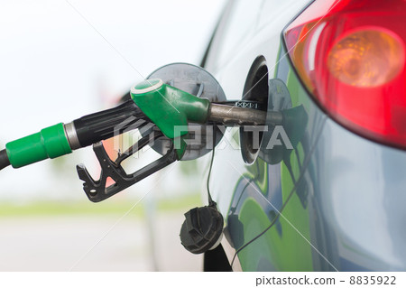 pumping gasoline fuel in car at gas station pumping gasoline fuel in car at gas station 8835922