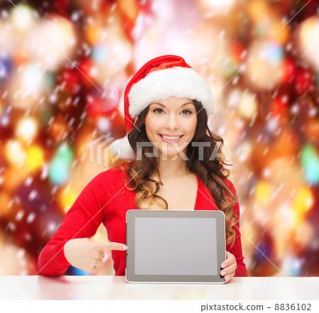 woman in santa helper hat with tablet pc 8836102