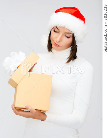 suspicious woman in santa helper hat with gift box suspicious woman in santa helper hat with gift box 8836239