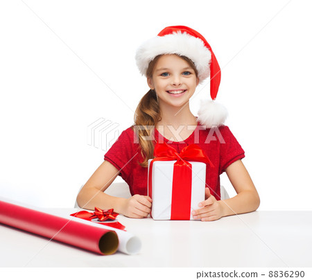 smiling girl in santa helper hat with gift box 8836290