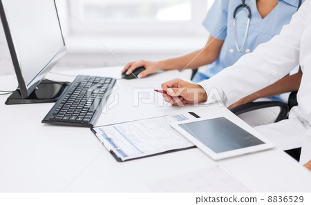 group of doctors looking at tablet pc