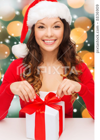 smiling woman in santa helper hat with gift box smiling woman in santa helper hat with gift box 8836909
