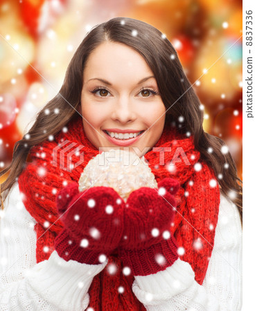 woman in scarf and mittens with christmas ball 8837336