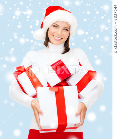 woman in santa helper hat with many gift boxes woman in santa helper hat with many gift boxes 8837544