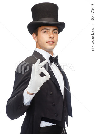 magician in top hat showing trick 8837569