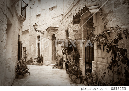 Retro photo of old narrow street 8858253