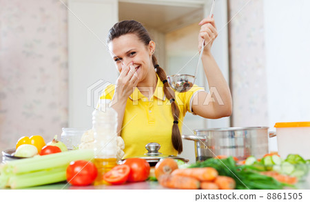 woman holding her nose because of bad smell from food 8861505