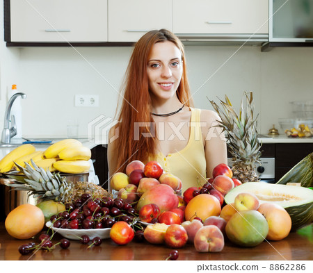 Positive girl with heap of fruits Positive girl with heap of fruits 8862286