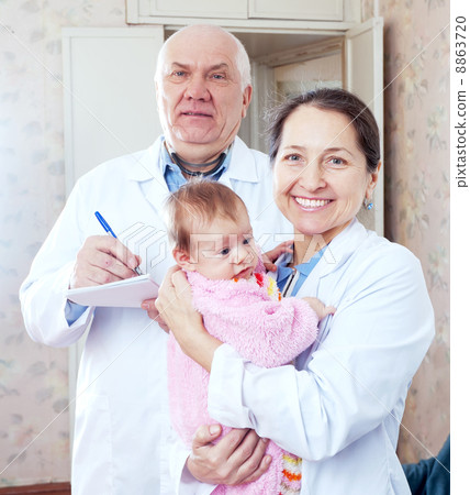 doctors with baby in interior 8863720