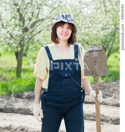 Female gardener with spade Female gardener with spade 8864043