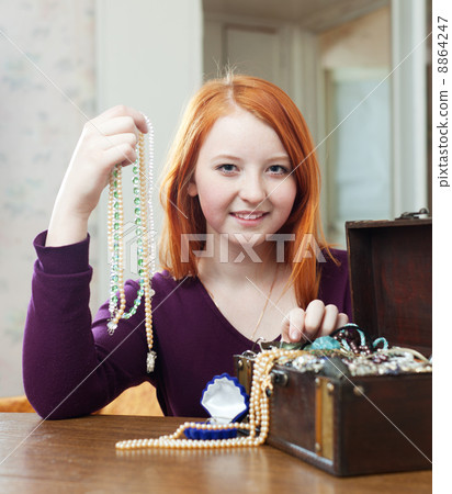 girl chooses necklace in treasure chest girl chooses necklace in treasure chest 8864247
