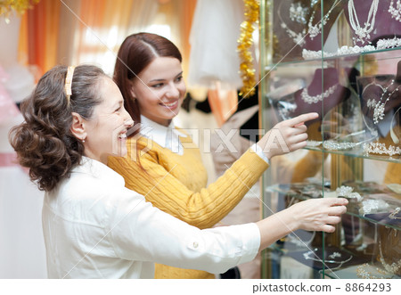 women chooses bridal accessories at store 8864293
