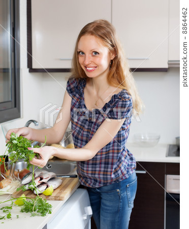 Smiling woman with raw fish and parsley Smiling woman with raw fish and parsley 8864462