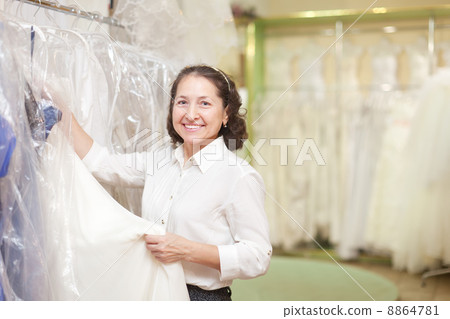 shop consultant at shop of wedding fashion 8864781
