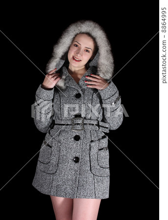 woman in gray coat on black background 8864995