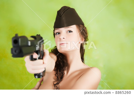 Topless girl aiming a gun 8865260
