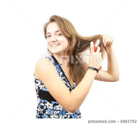 girl spraying hair lacquer onto her hair girl spraying hair lacquer onto her hair 8865792