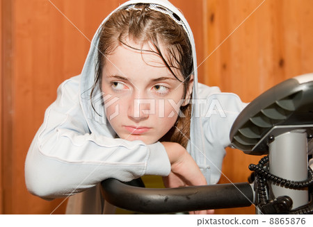 weariness girl on exercycle weariness girl on exercycle 8865876