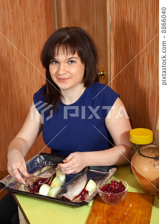 woman prepares the mackerel with cranberries woman prepares the mackerel with cranberries 8866040