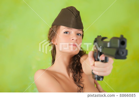 Topless girl aiming a gun 8866085