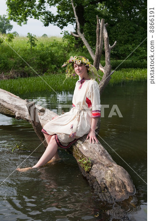 Pretty girl in flower chaplet at river Pretty girl in flower chaplet at river 8866191
