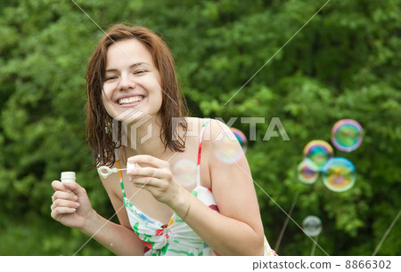 Happyy girl making soap bubbles 8866302