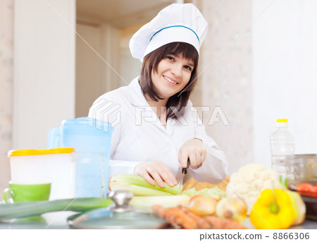 female cook with celery on cutting board 8866306