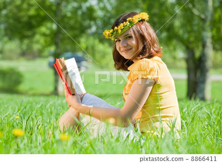 girl reading book in grass girl reading book in grass 8866411